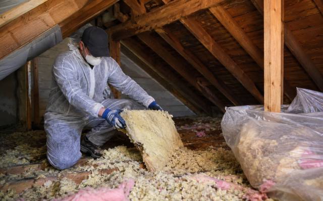 Old insulation being bagged out of an attic in New Hamburg